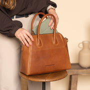 Styled Fit Perspective of Marsala Full-Grain Leather Handbag レディース on Model - Natural Daylight Drape