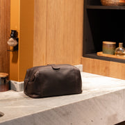 Styled Fit Perspective of Vince Full-Grain Leather Toiletry Bag レディース on Model - Natural Daylight Drape